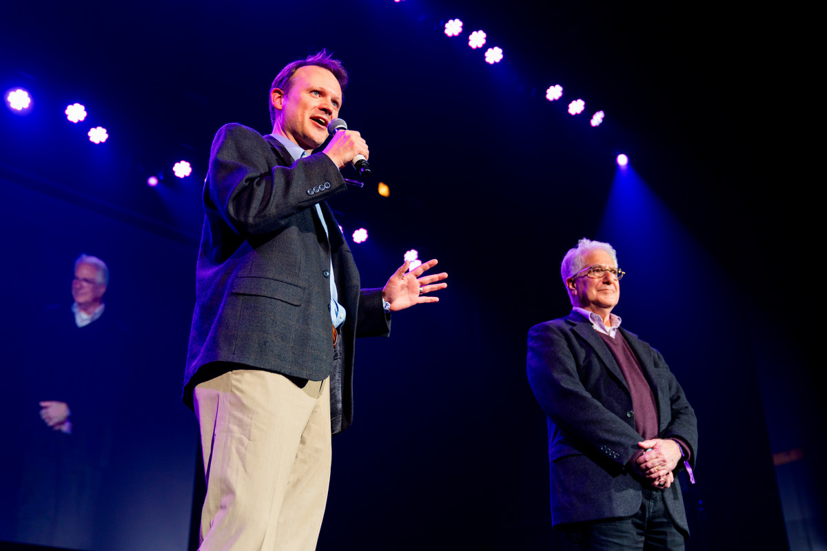 man on a stage giving a seminar 